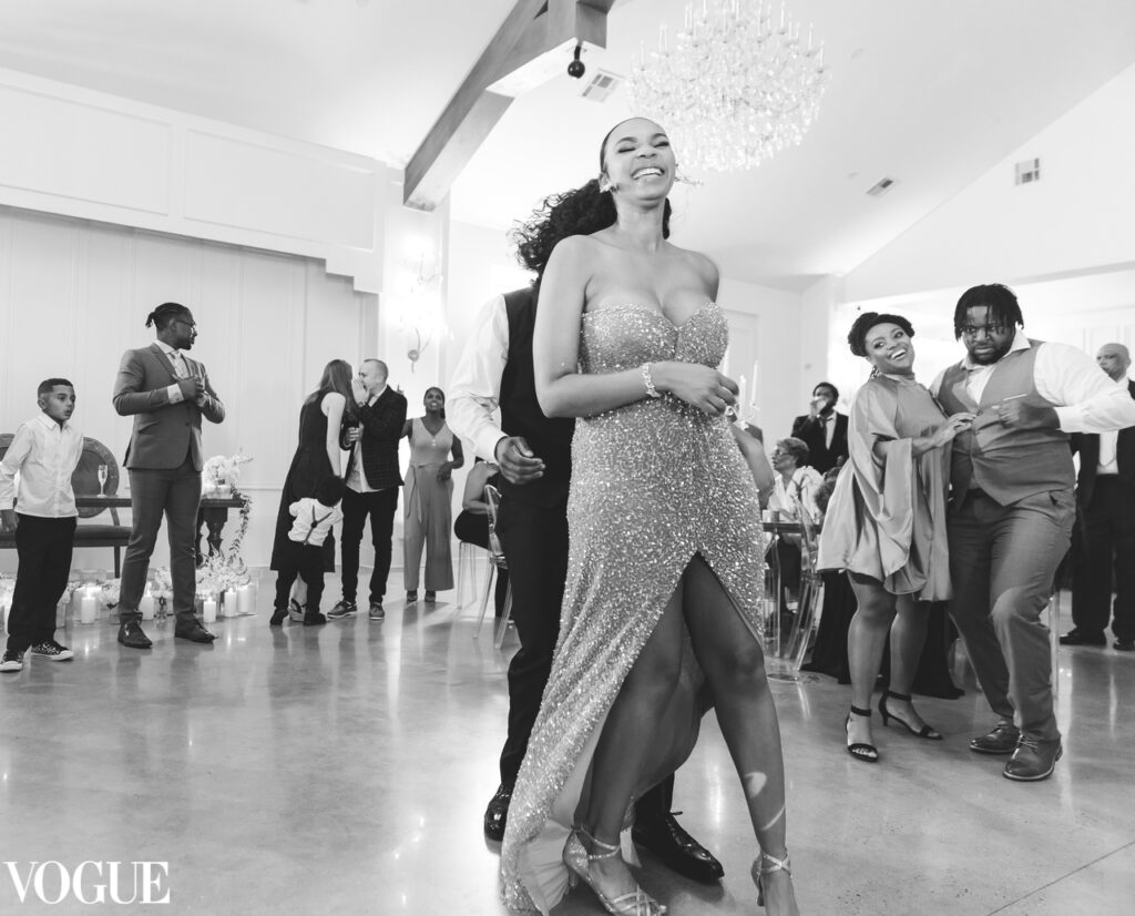 Joanna Booth weddings shows one of her vogue featured images of the bride on her wedding day dancing and smiling and being happy at the Peach Orchard Venue in Houston Texas