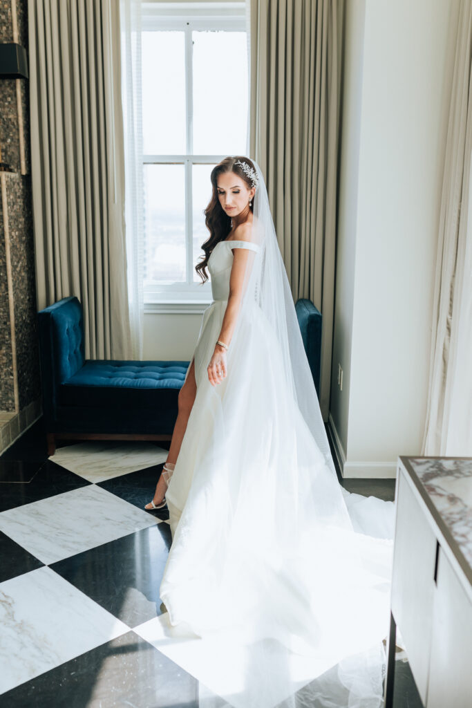 Joanna Booth Weddings captured a bride in her wedding gown in the penthouse suite of the magnolia hotel in Houston, Texas in a vogue posing style.